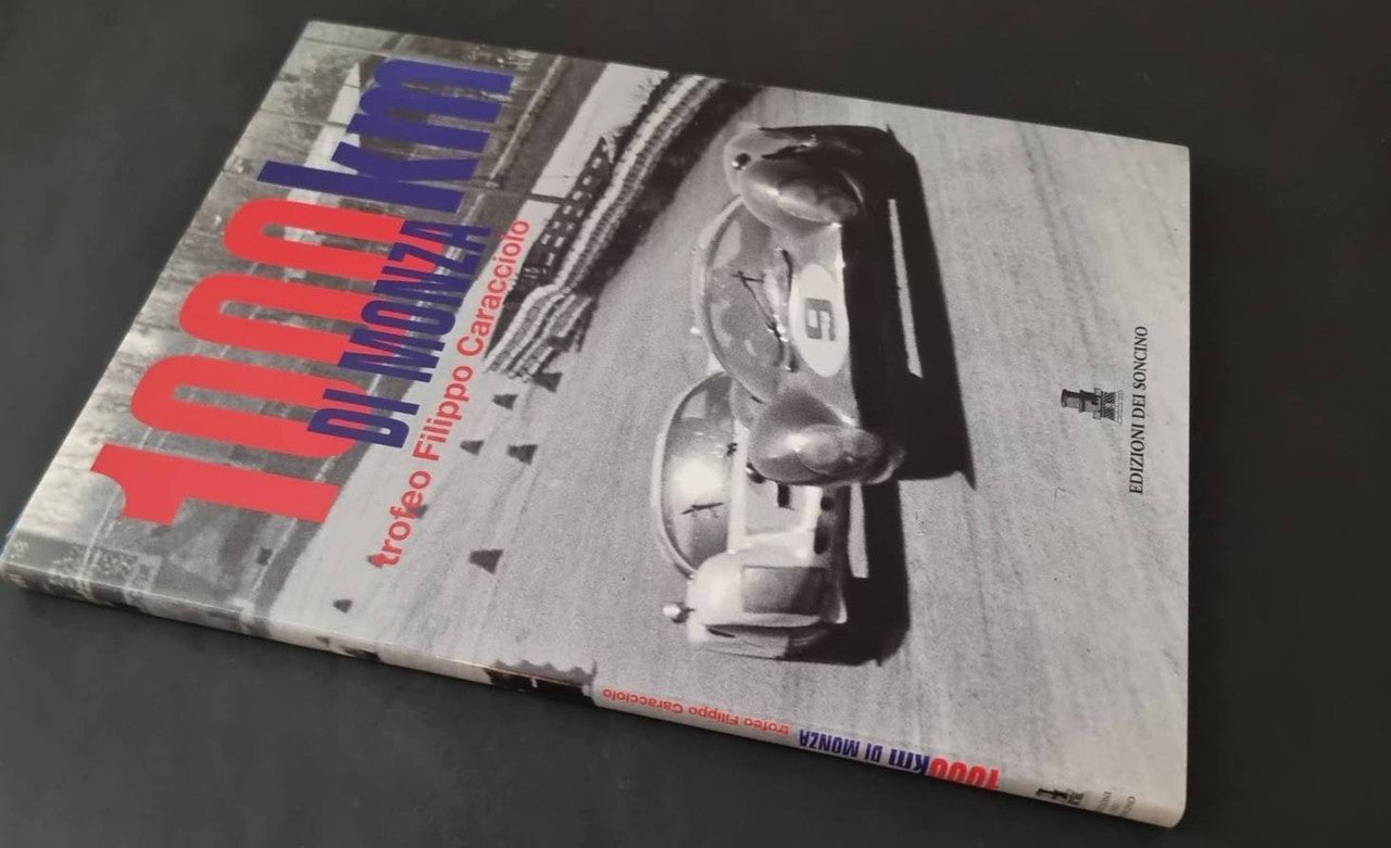 Motorsport book cover with classic race car photo and blue title text layout