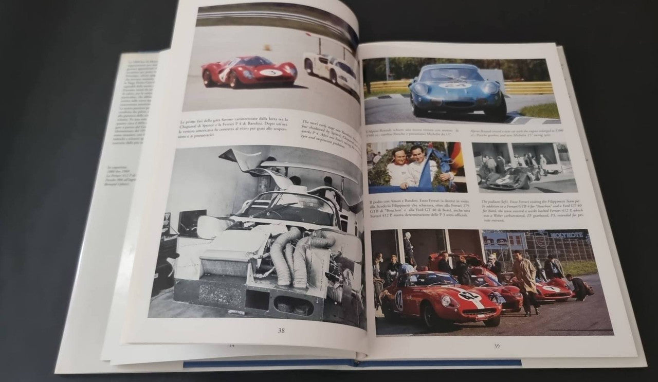 Open motorsport book spread with red and blue car images and multiple photo blocks