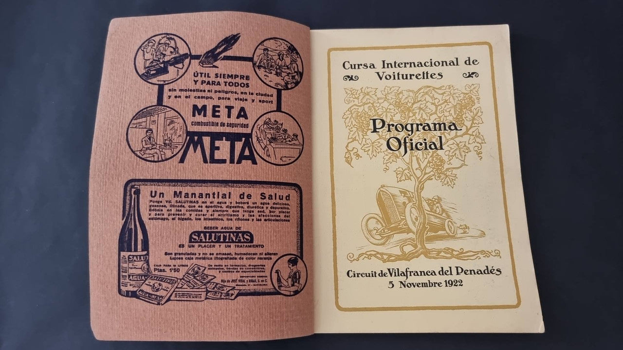 Vintage open booklet showing Meta logos and an official program title page