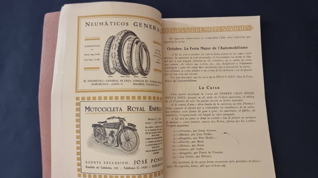 Vintage open booklet with tire illustrations, motorcycle image, and printed article text