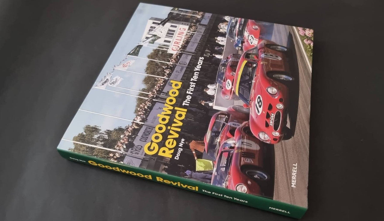 Motor racing history book with colorful vintage race cars on the cover