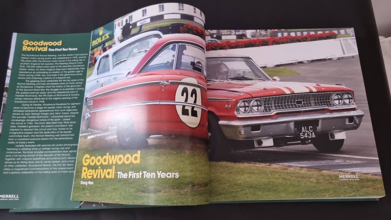 Open book spread with red vintage race cars and a green title panel