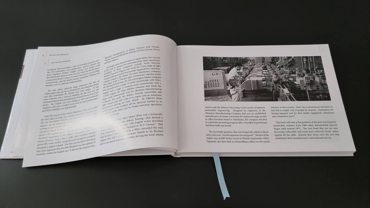Automotive photo book by Gavin Farmer, open pages with text and black-and-white car spread