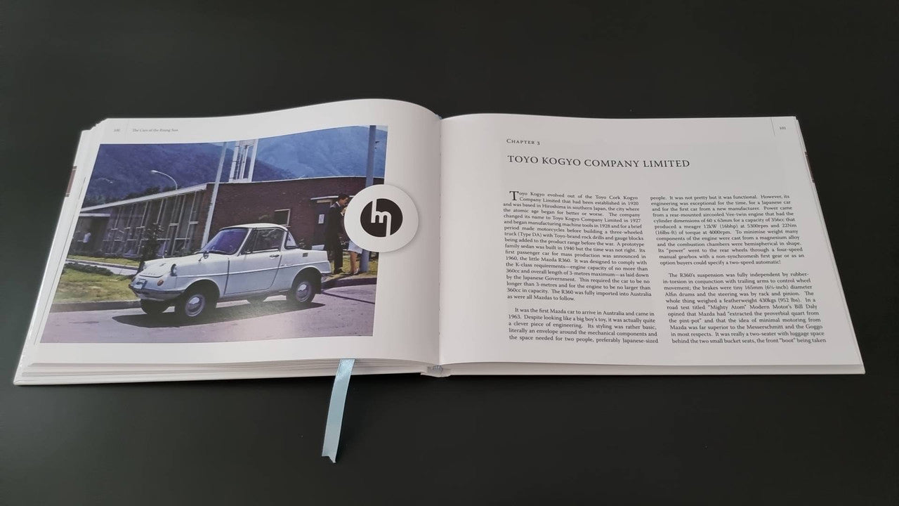 Book open with a white van photo and article text on the right page