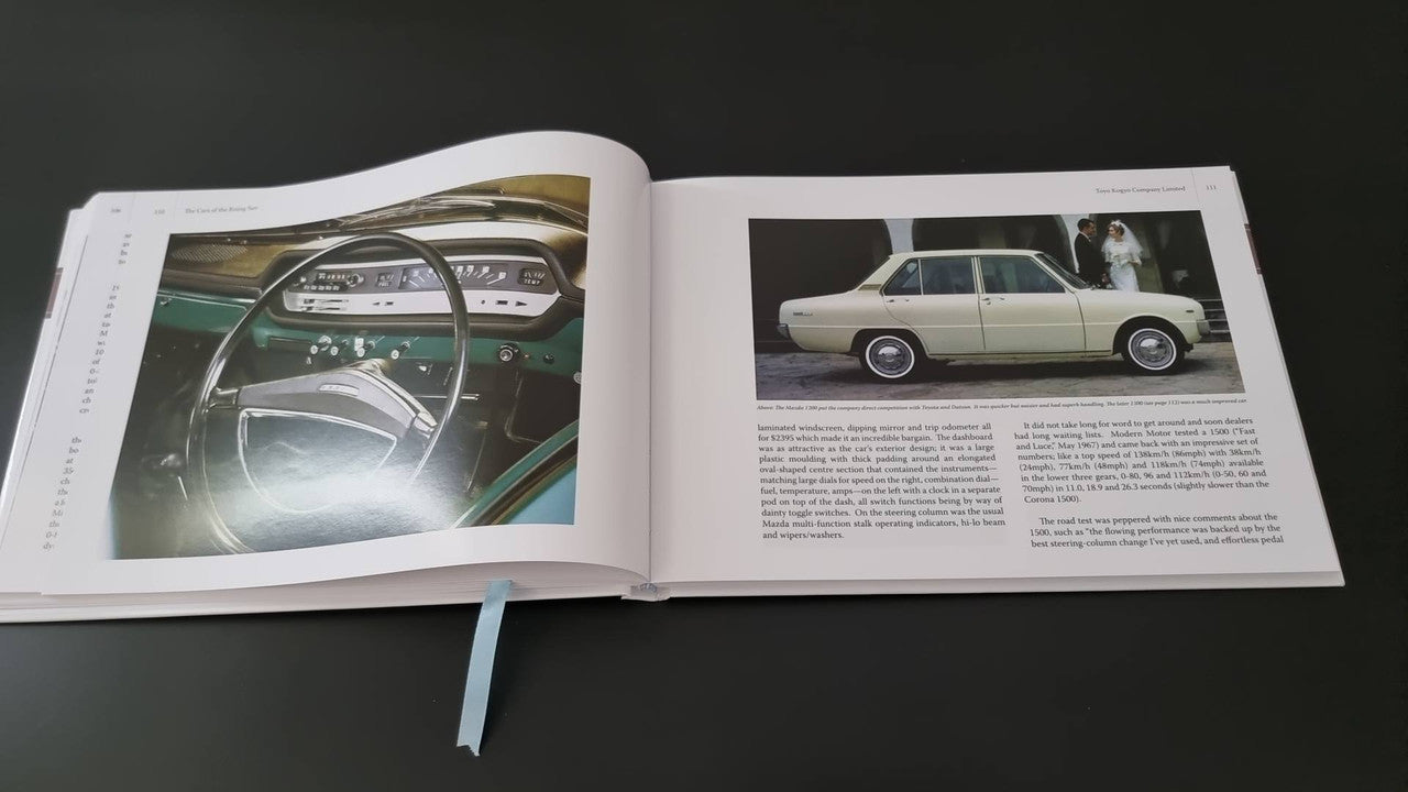 Automotive photo book by Gavin Farmer, open pages with interior steering photo and car profile