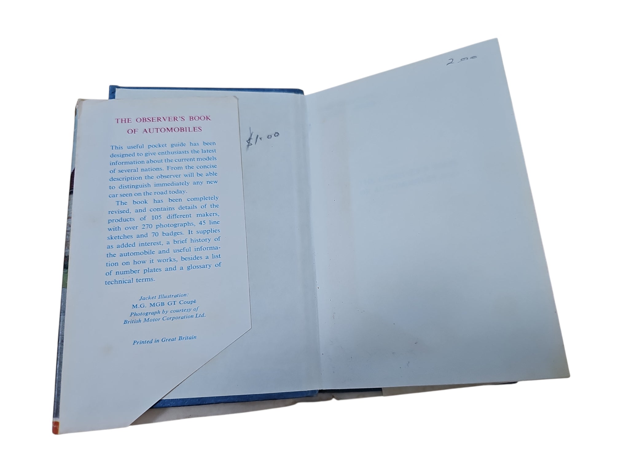 Open vintage automobile book angled view with dense text on the left and blank right page