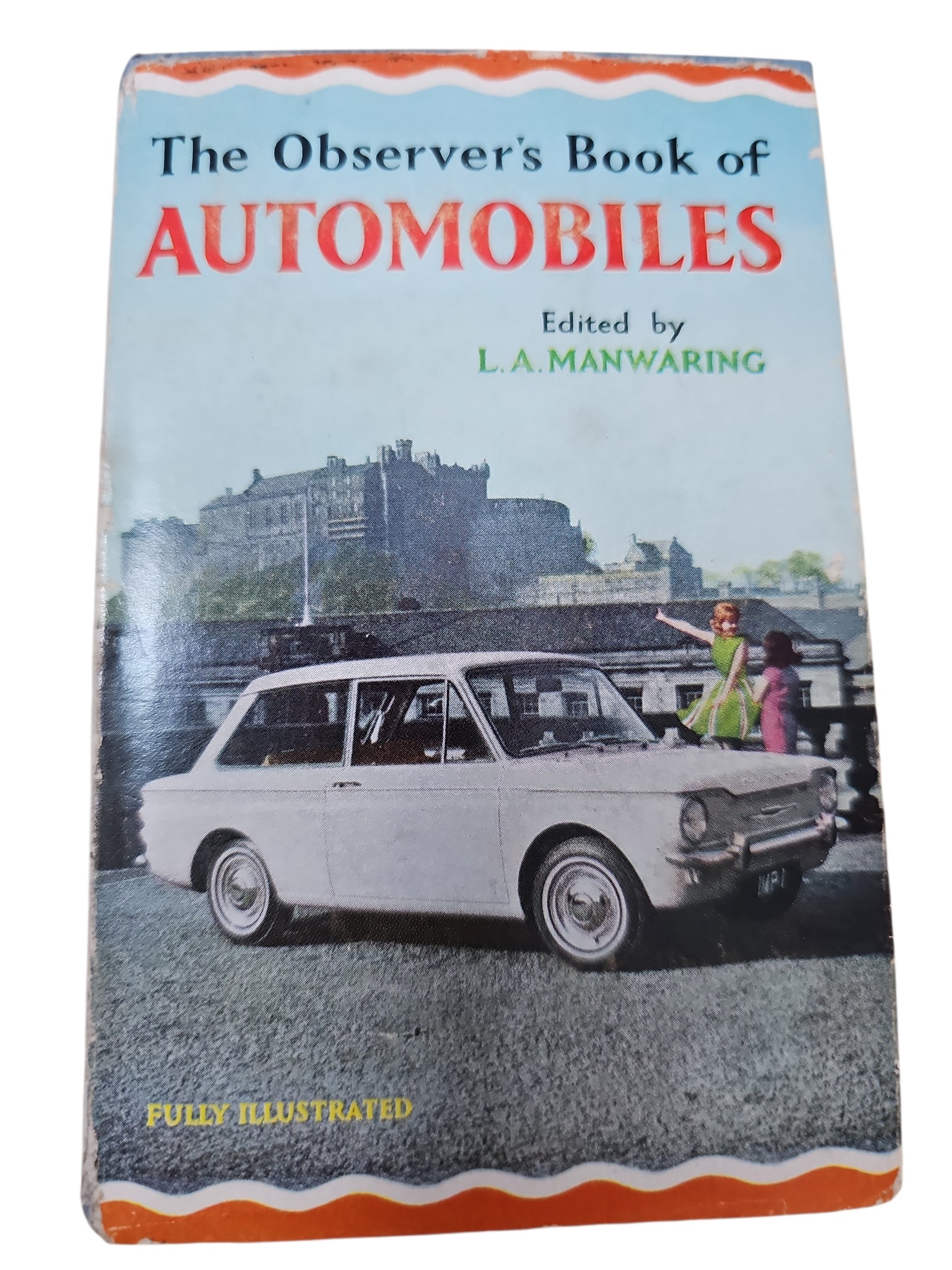 Automobiles book with blue cover and red title, featuring an illustrated classic car front