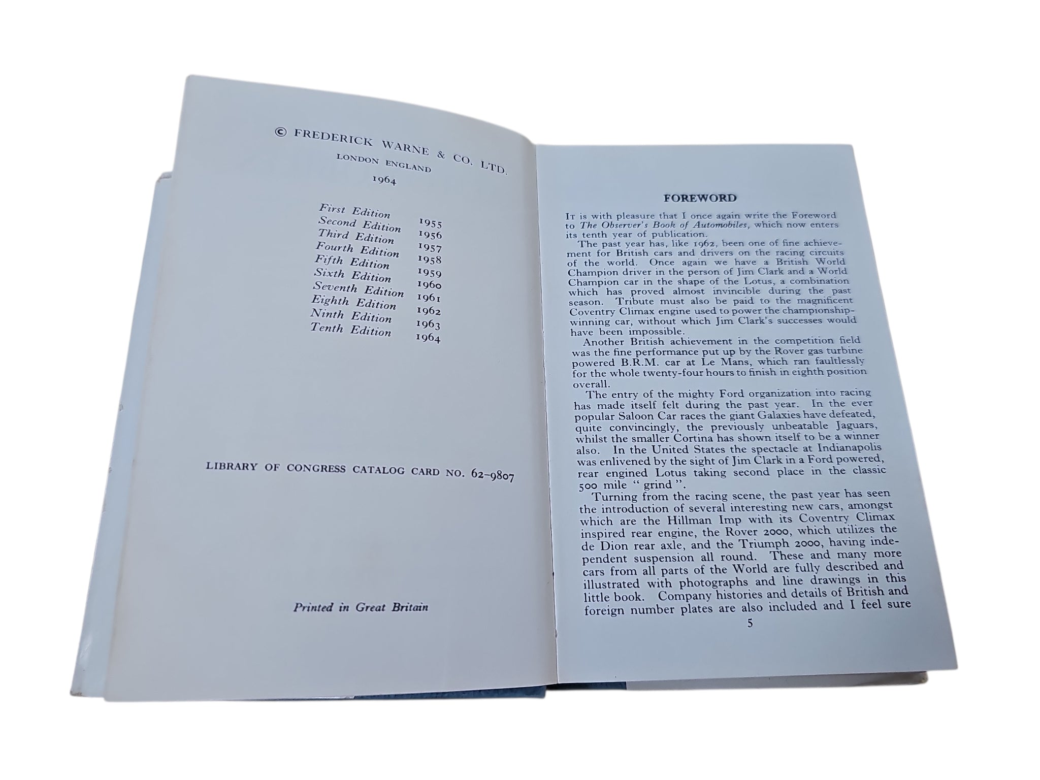 Open hardcover book with two printed pages and dense text columns visible