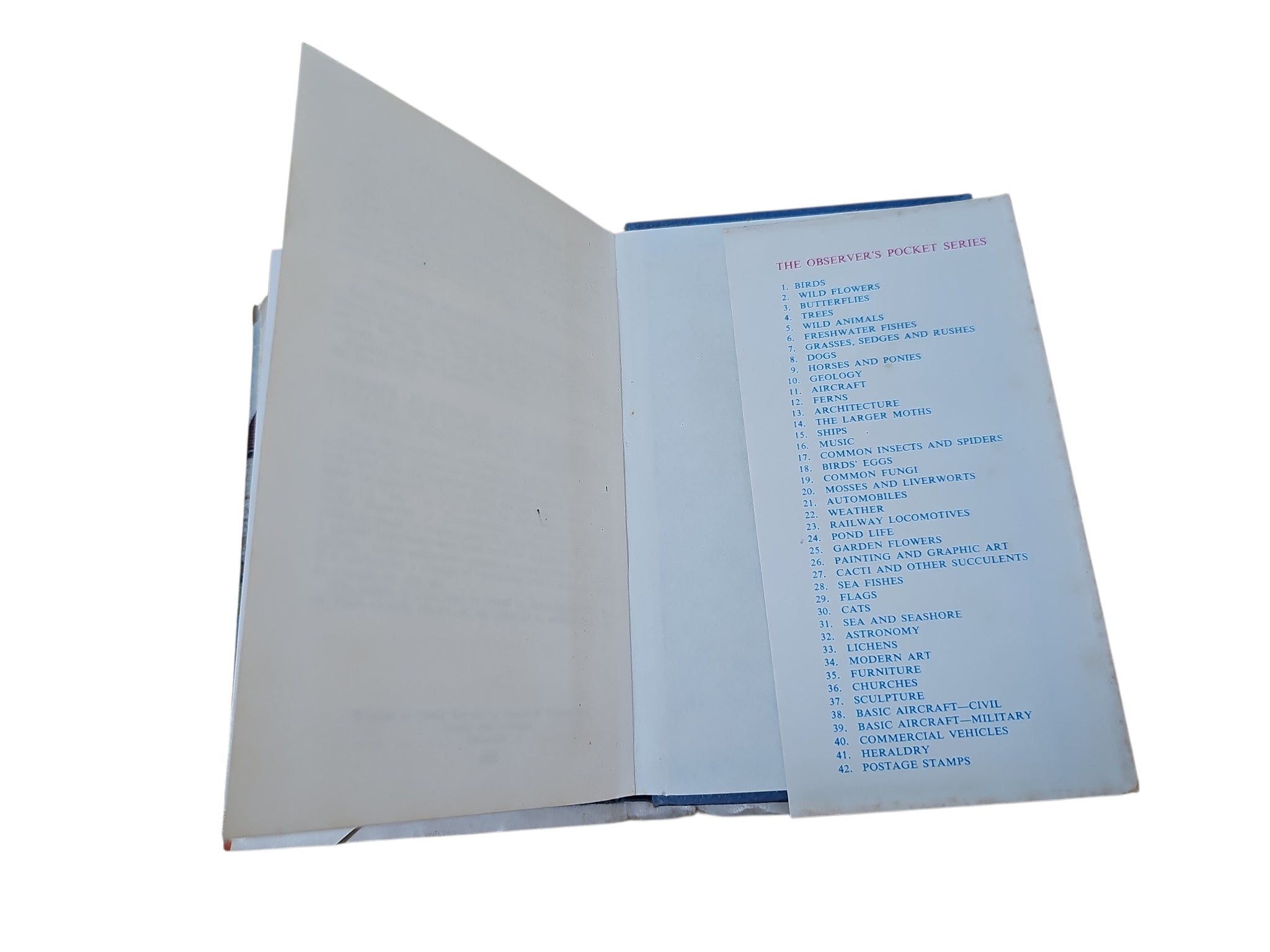 Open vintage automobile book with a mostly blank page and a printed contents list