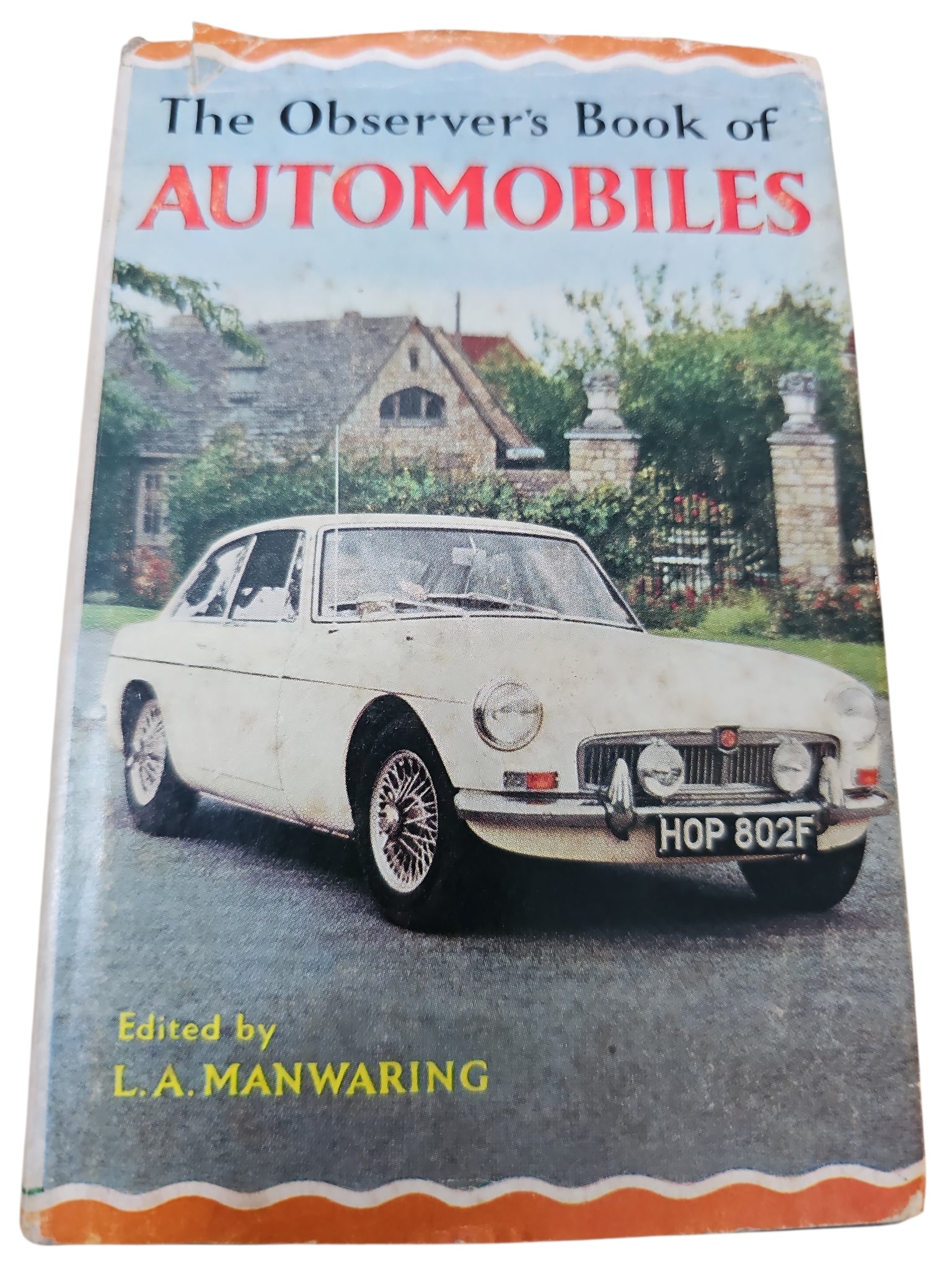 Vintage automobile book with white classic car on the cover and bold title text