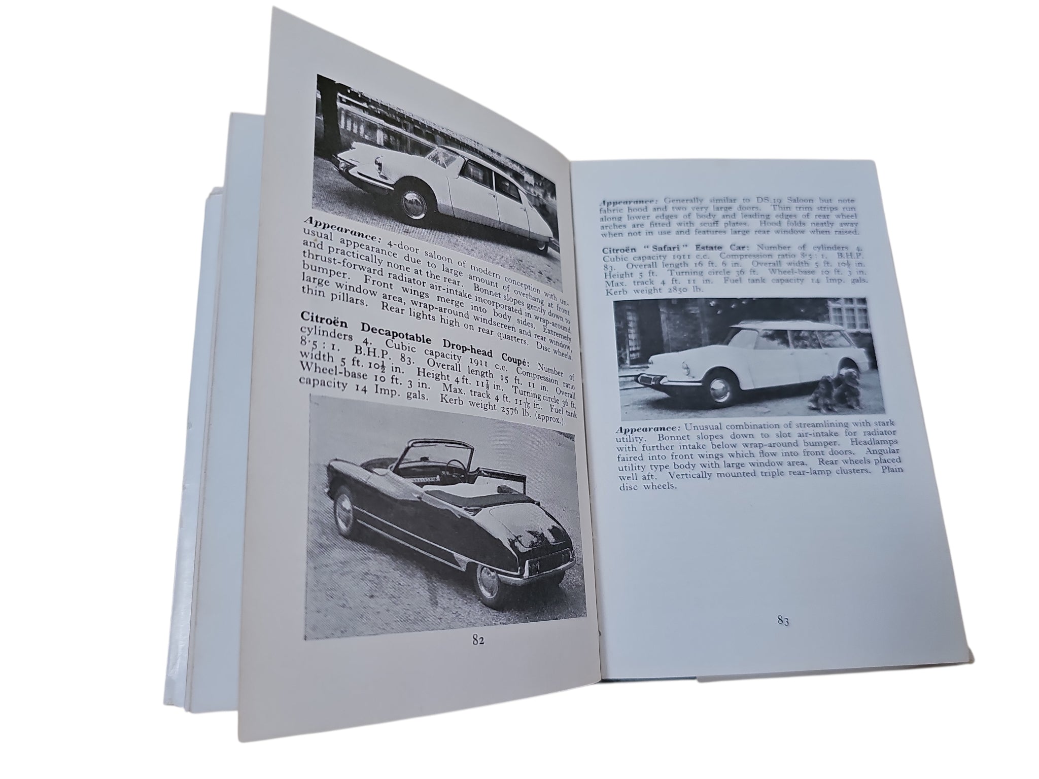 Opened book spread with car photos and paragraphs, showing vehicle captions on both pages