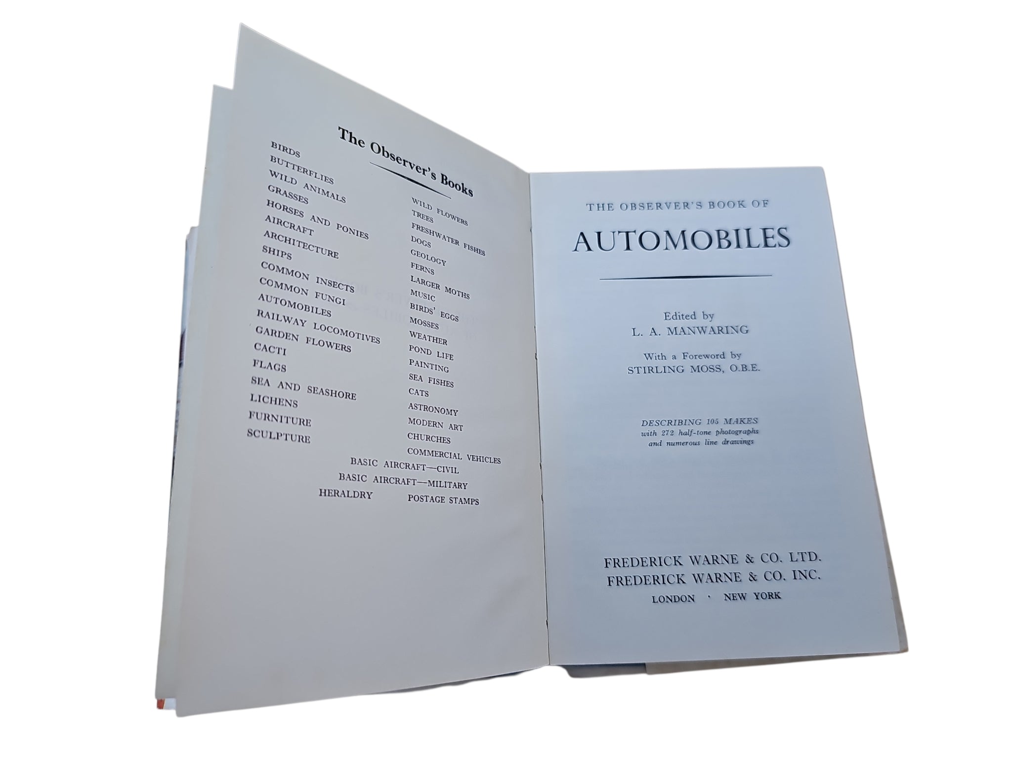 Open vintage automobile book with text lists on the left and title page on the right