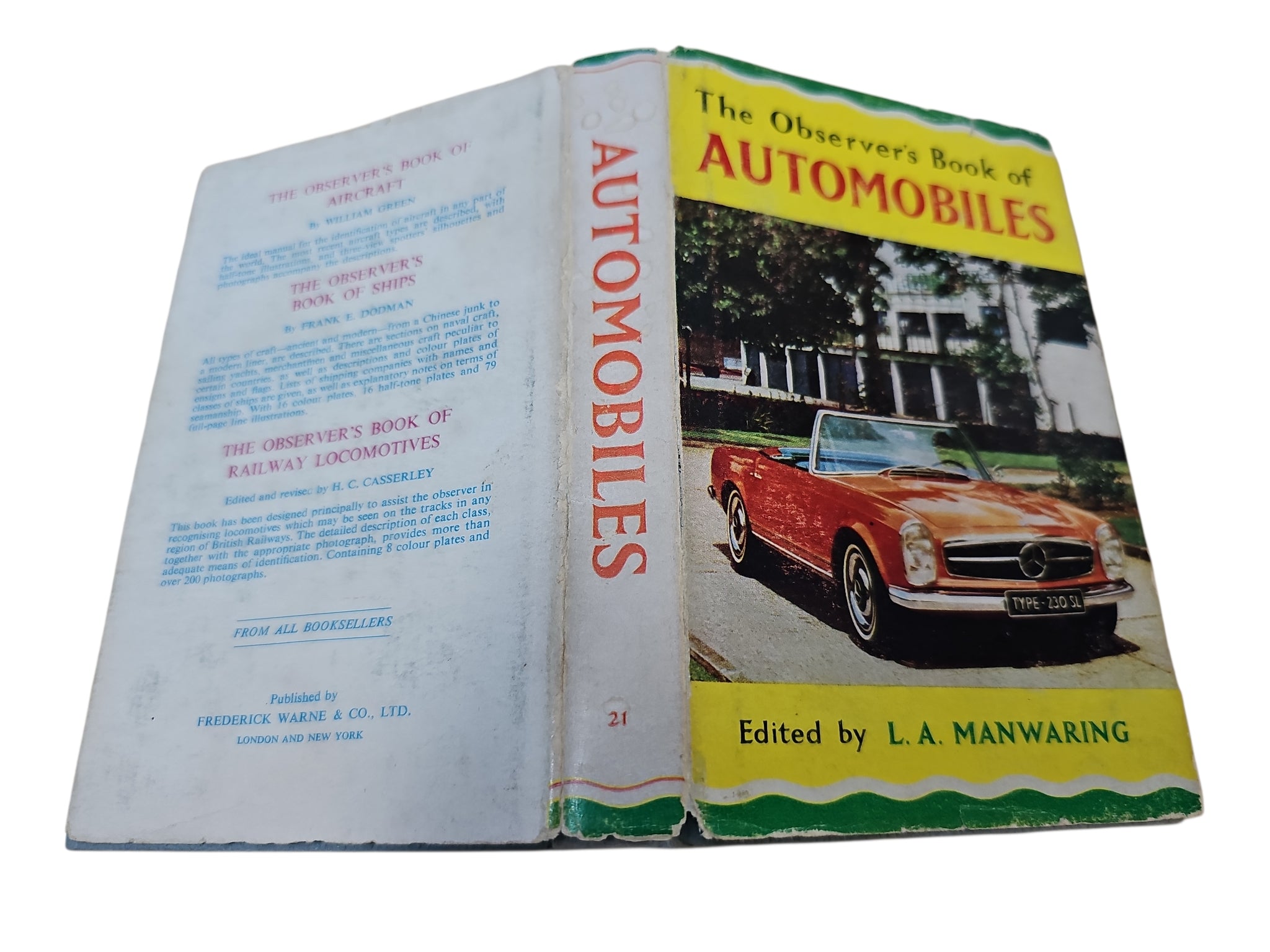 Vintage automobiles book opened to show cover with red car and title strip