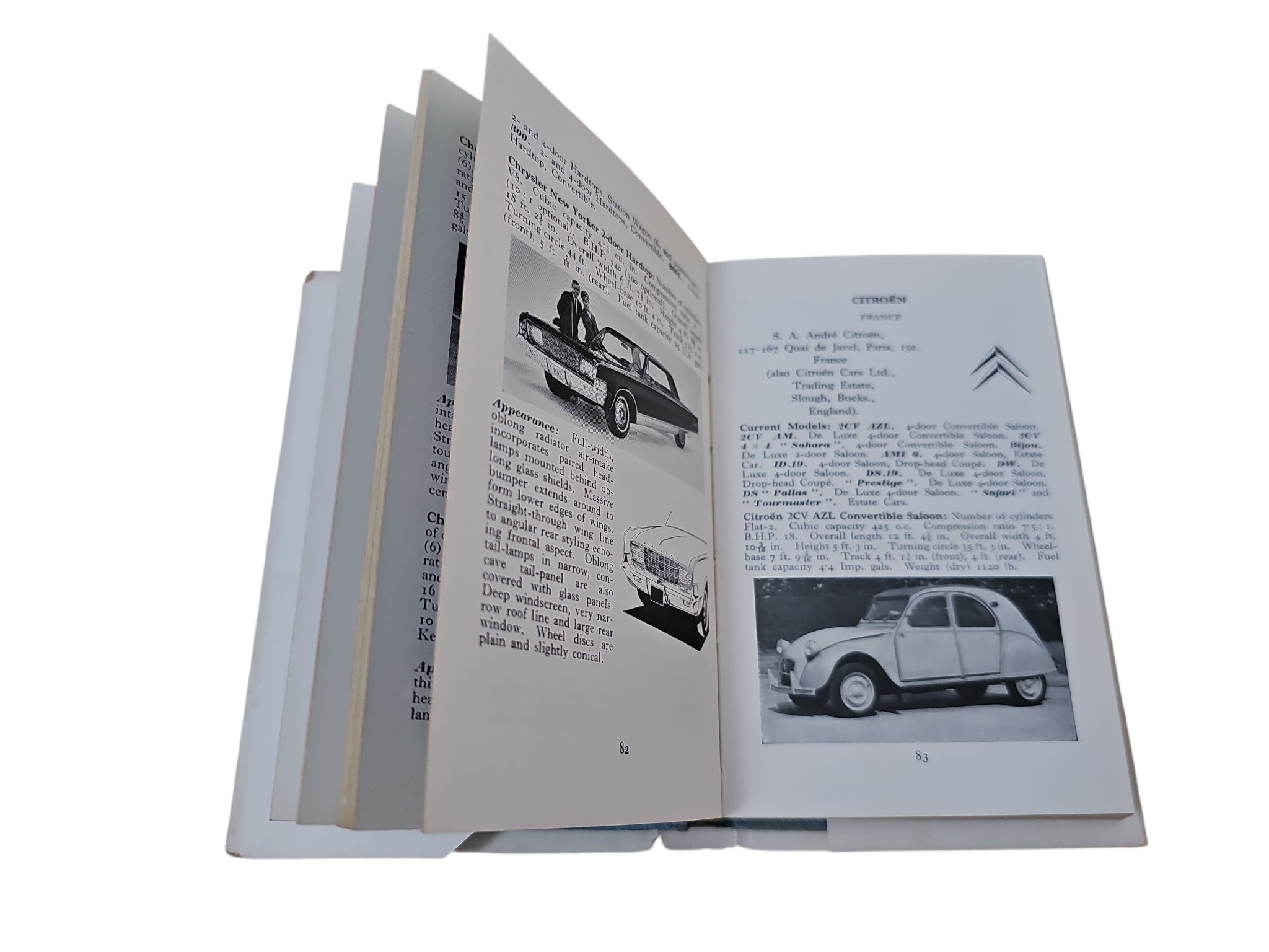 Open automobiles book with car photos and paragraphs on two pages