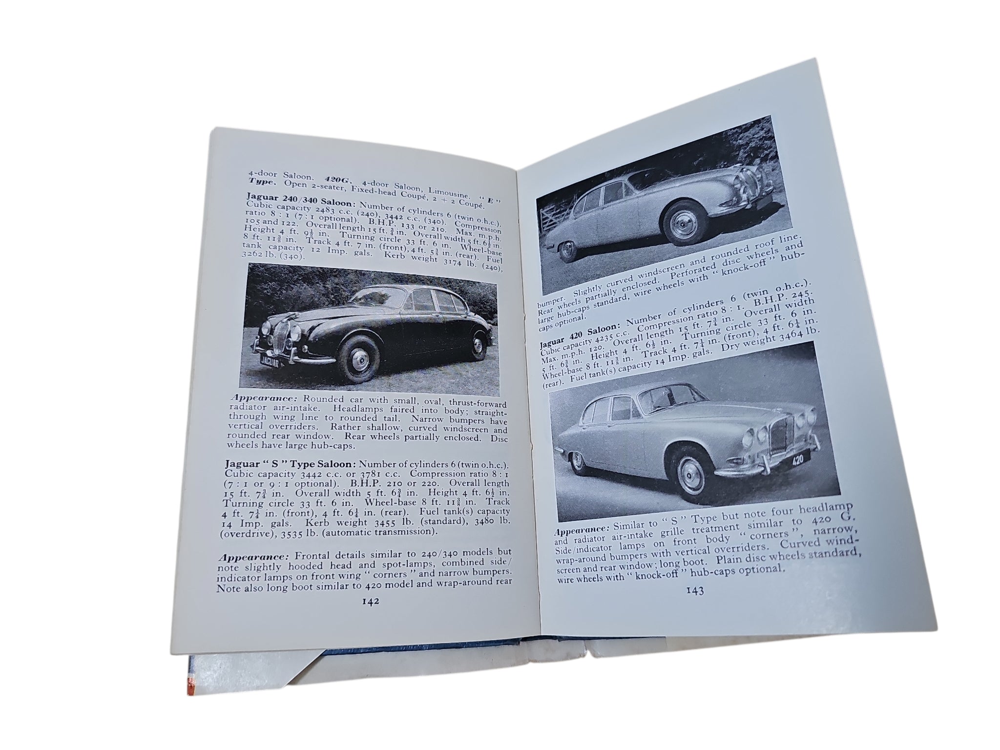 Open vintage automobile book showing printed pages with small car photos and captions