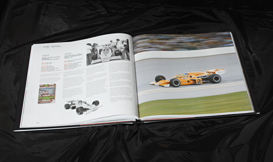 Open racing book with car photo on right page and diagram text on left