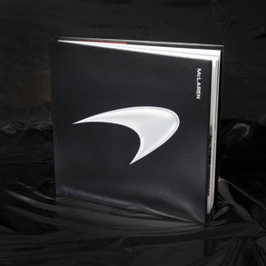 Hardcover racing book with black cover and white McLaren logo