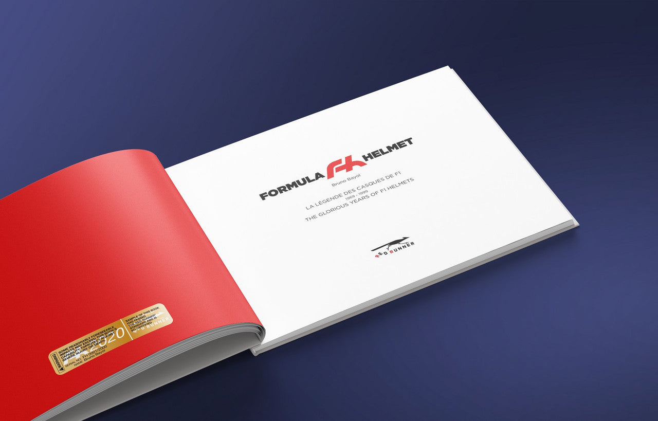Opened helmet-themed book with white interior pages, showing title text and a red edge.