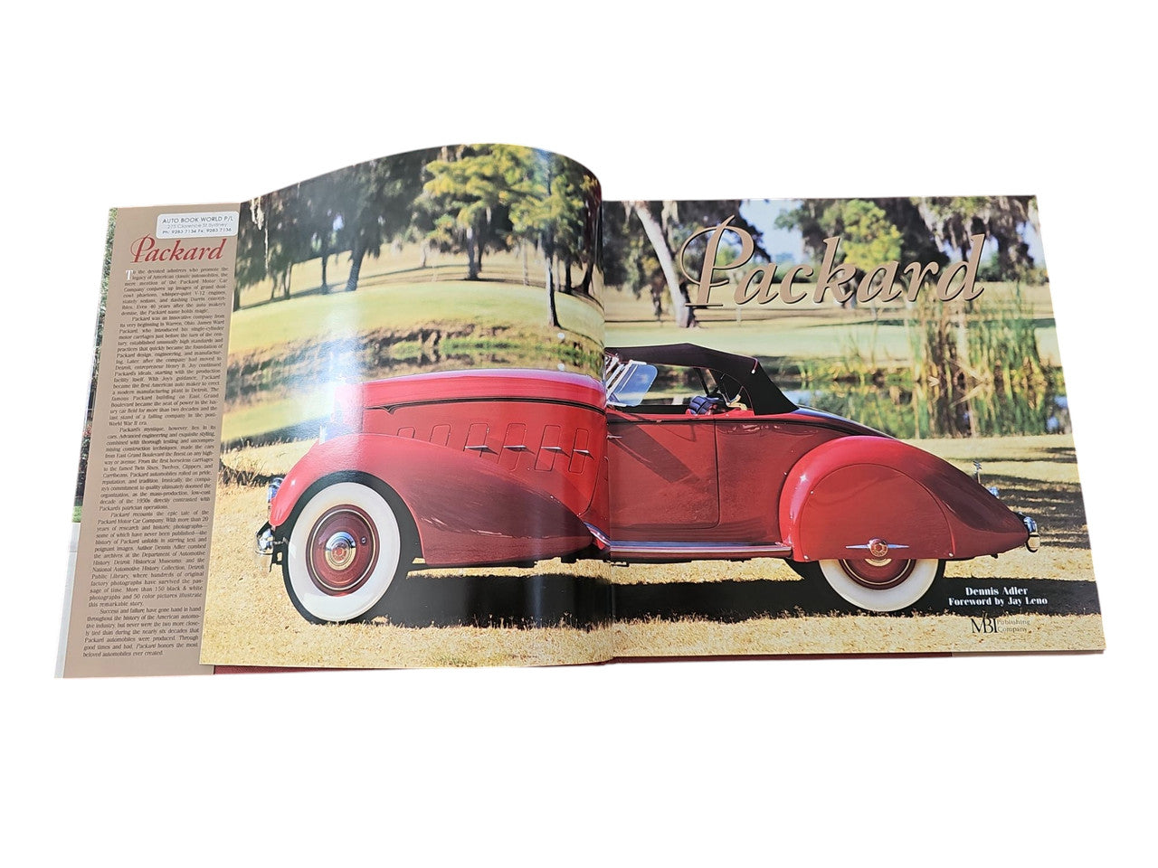 Open book spread with vintage red car photo and large title lettering.