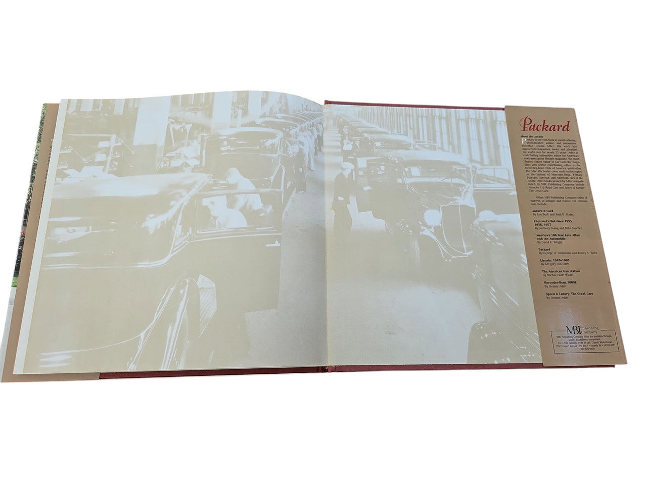 Packard hardcover book open pages with tinted car photos and a vertical text column