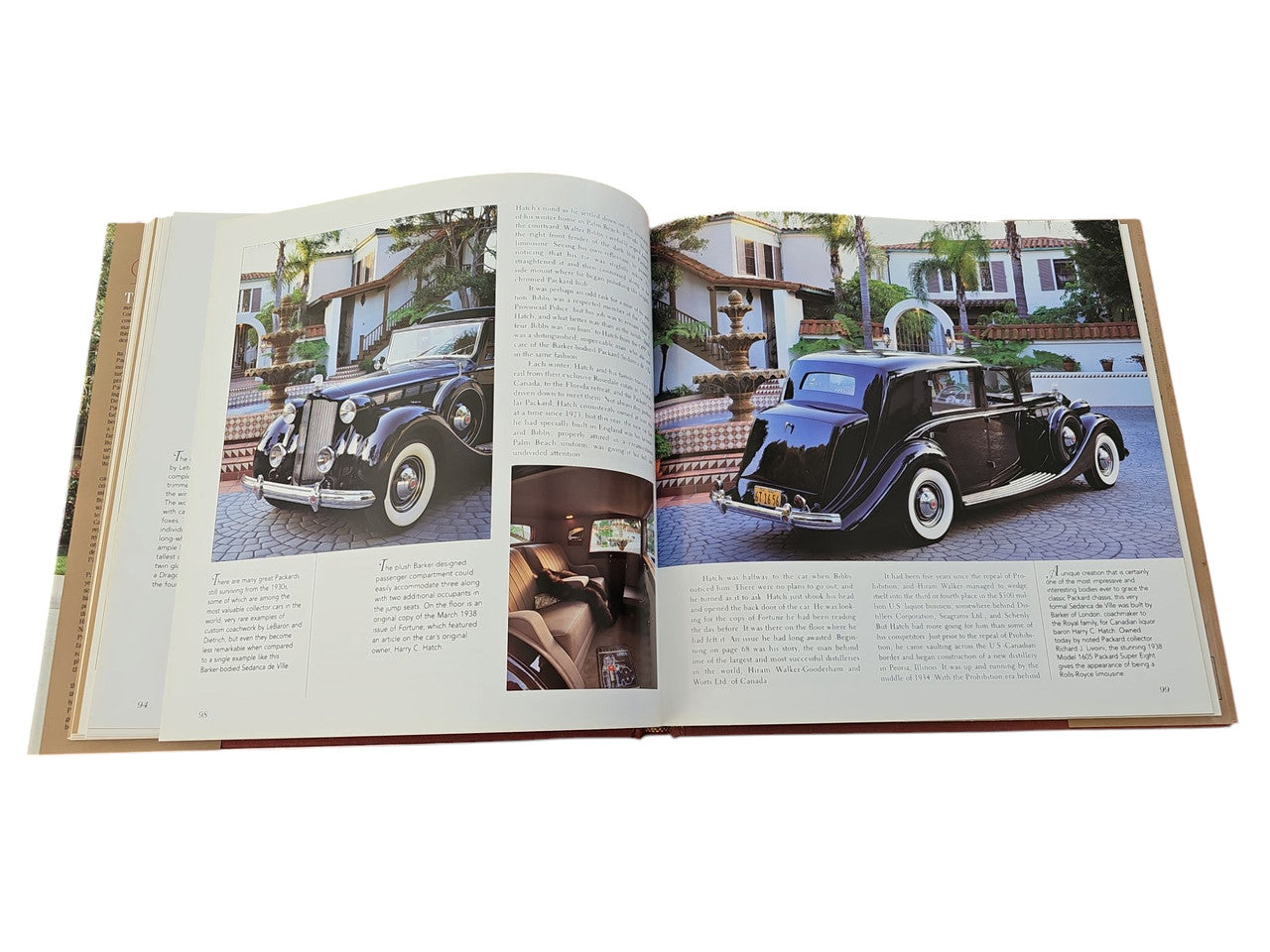 Packard hardcover book open spread with two color car photos and paragraph text