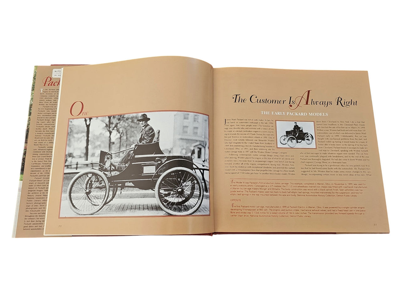 Packard hardcover book open pages featuring a vintage car photo and a headline