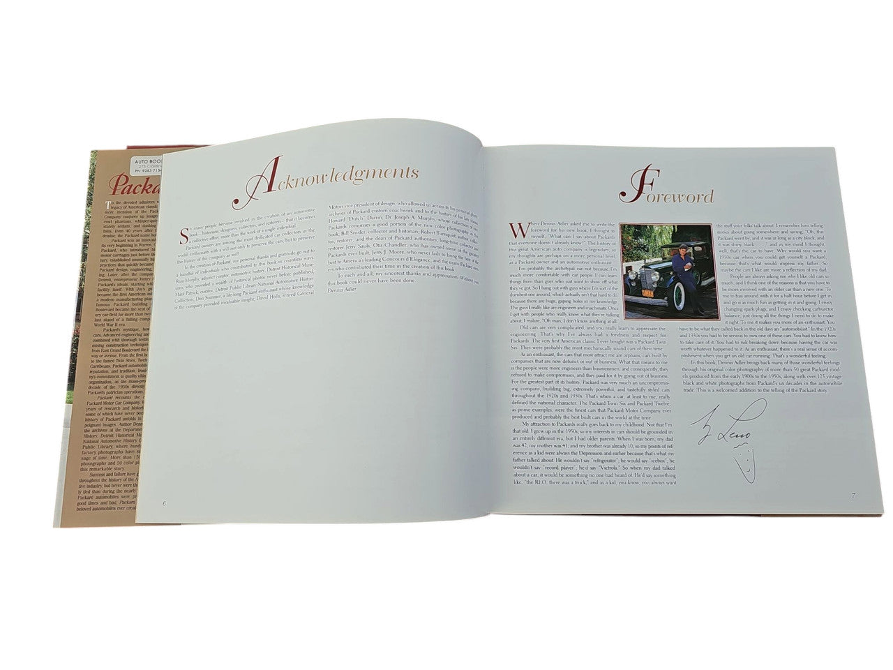 Open book with two light-gray pages; small car photo on right page.
