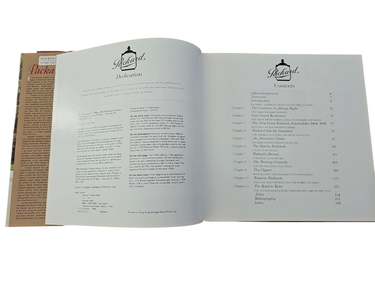 Open book with two light-gray pages; dense text columns and headings.