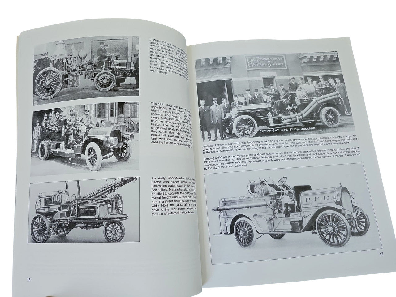 Fire engines guidebook open to black-and-white fire engine photos and caption text