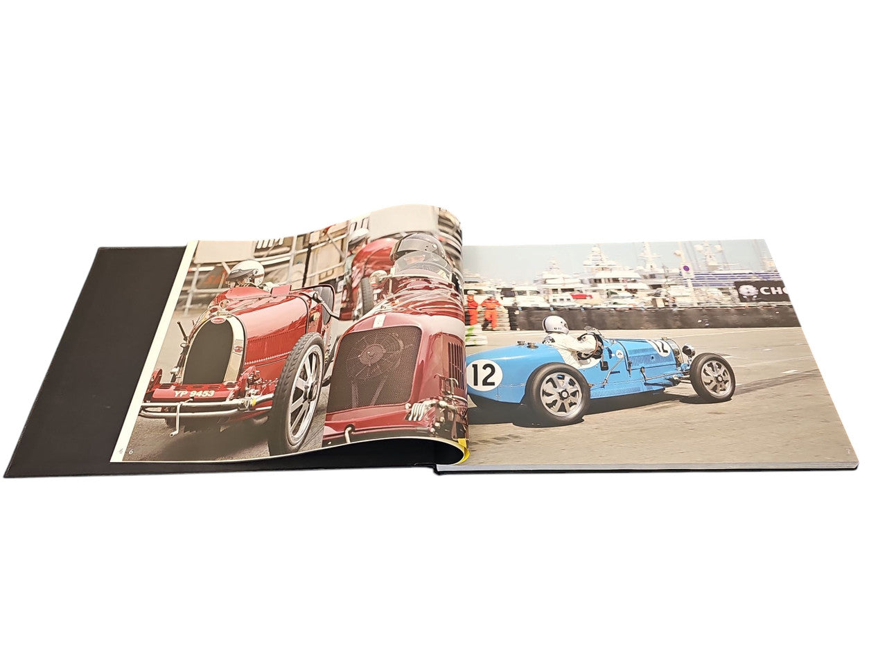 Race Face racing book open to spread with red and blue vintage cars