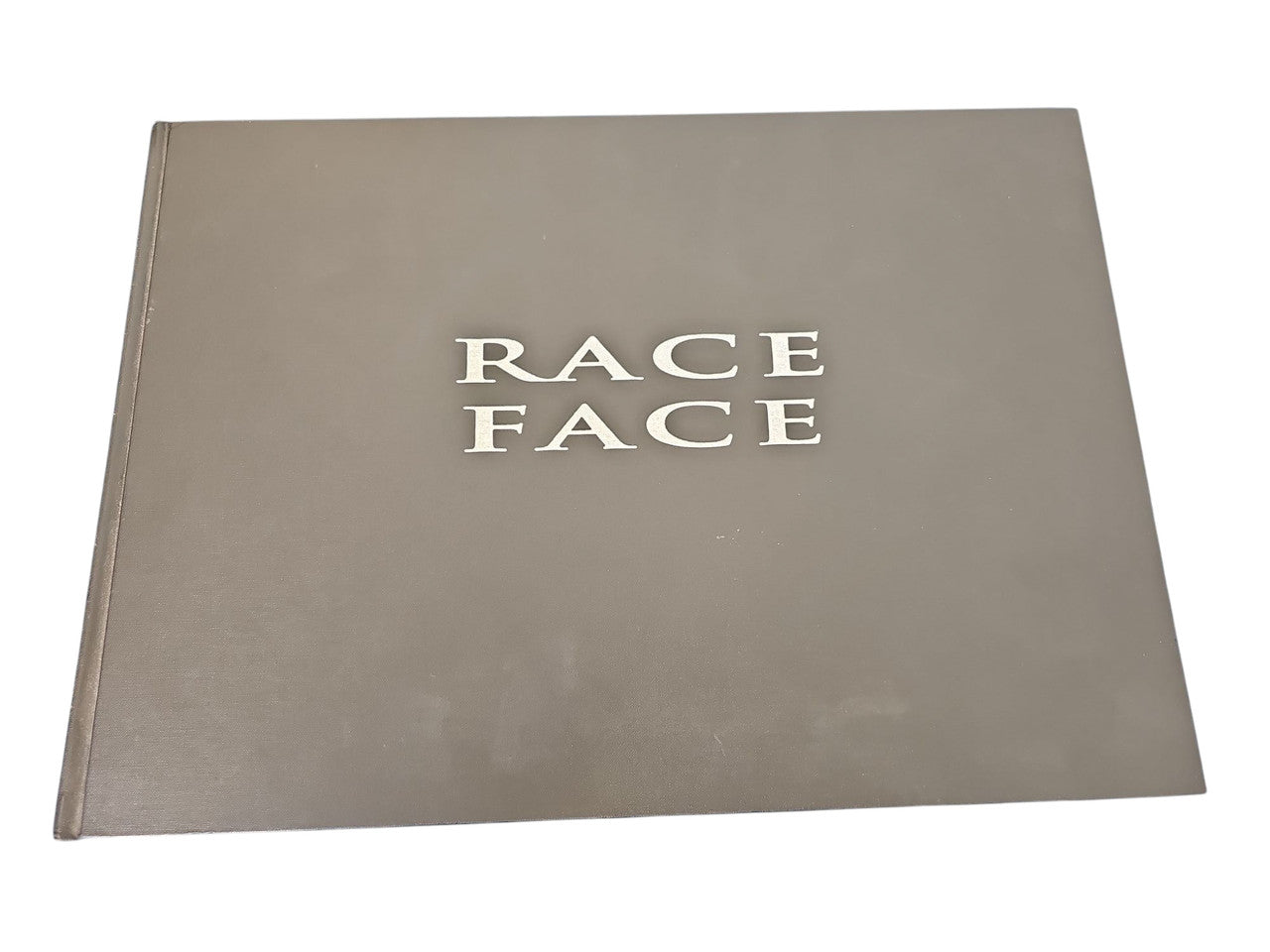 Signed commemorative race album cover, gray front with Race Face title