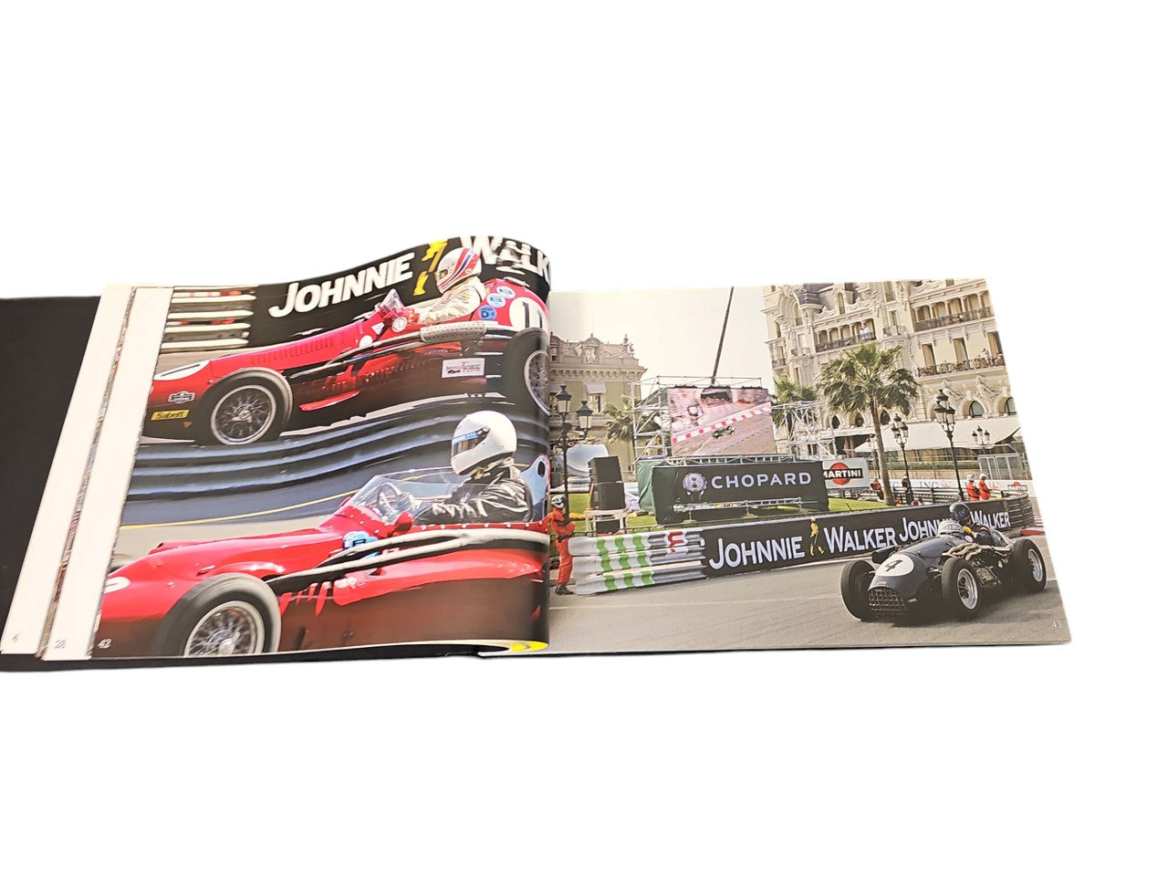 Commemorative race photo album spread with red race car and Monaco buildings