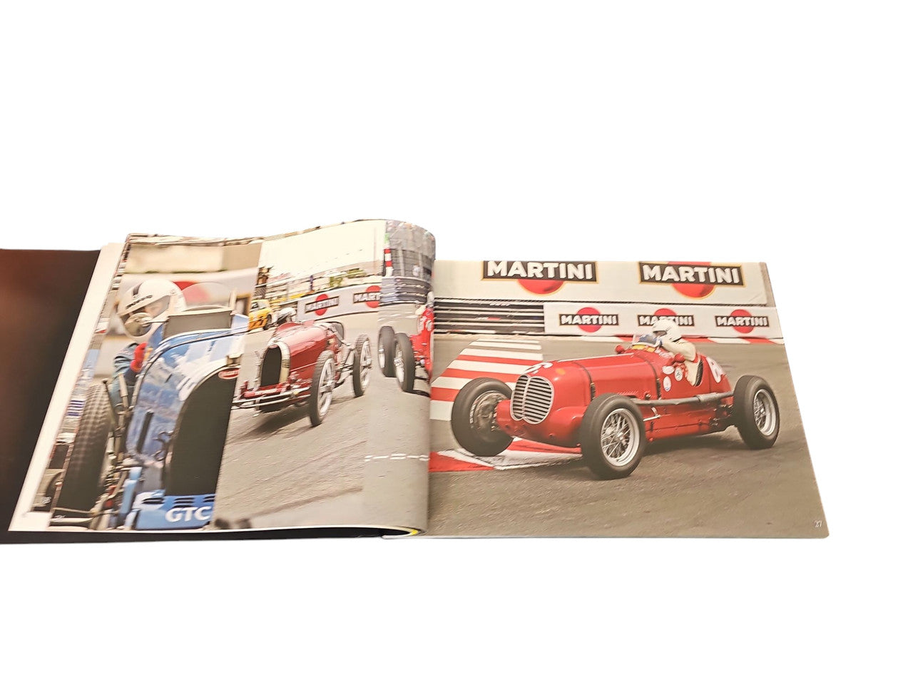 Race Face racing book open to two-page spread with red and blue race cars