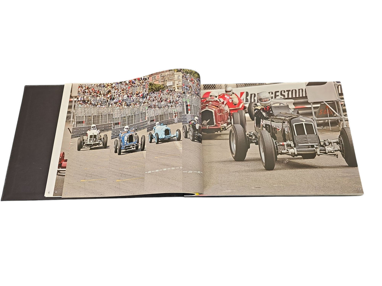 Race Face racing book open to spread showing classic cars on a track