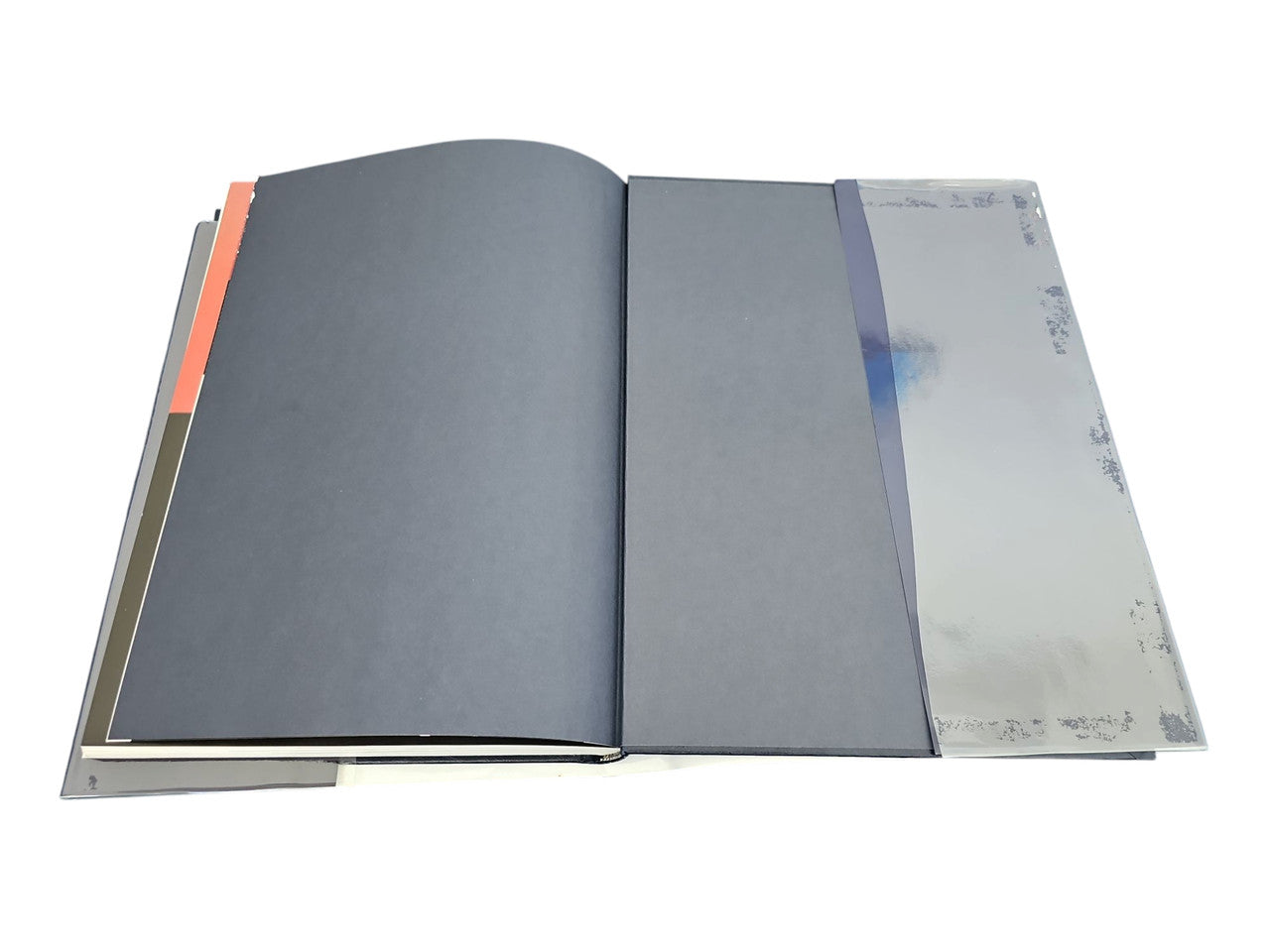 Open hardcover car portfolio book with dark blue page sections and text