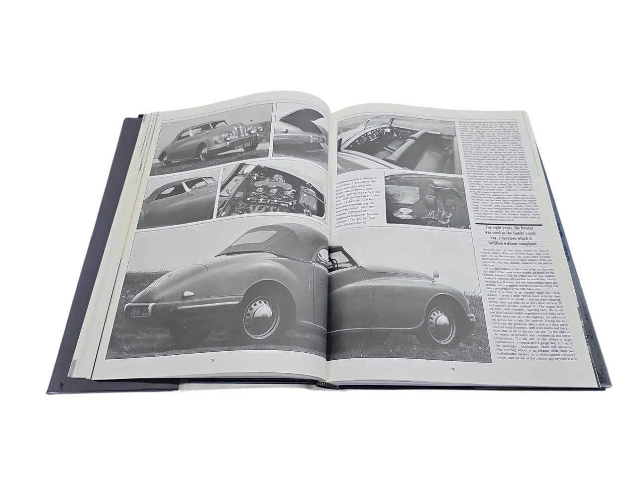 Open hardcover car book showing grayscale car photos across two pages