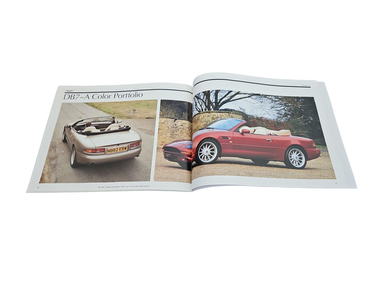 Automobile photo book open to a two-page spread with red and silver car images