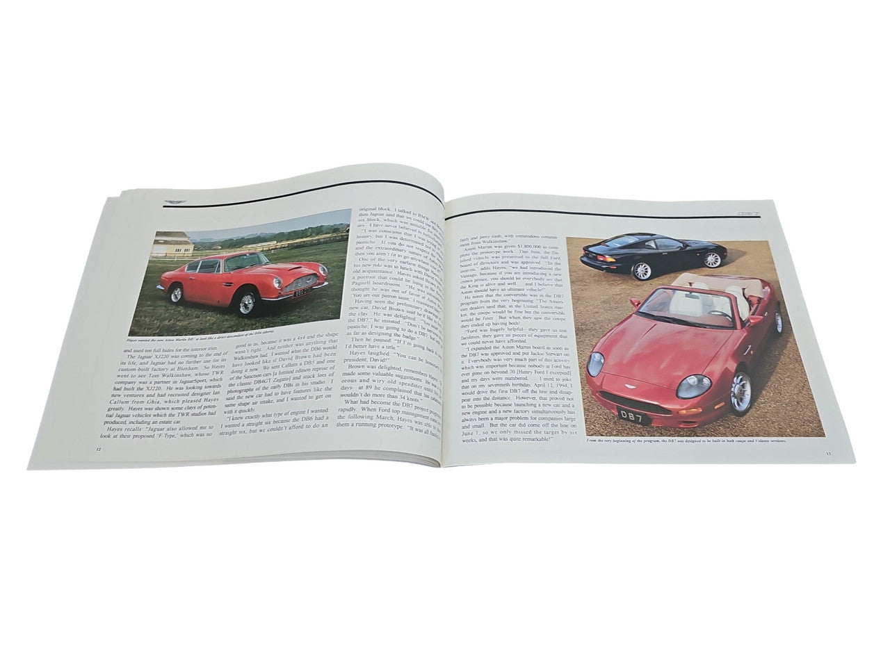 Open book spread with car photos and surrounding paragraphs on off-white pages