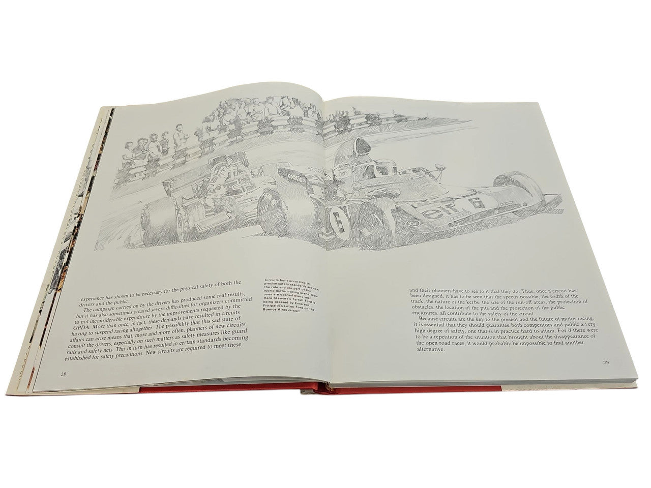 Opened book with grayscale illustration across the page and paragraphs of text below.