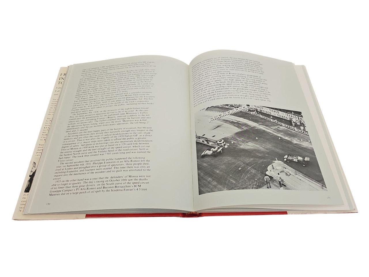 Opened book spread showing paragraphs of text and a grayscale racing photo inset.