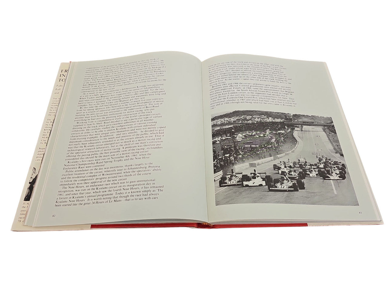 Open book spread with dense text paragraphs and a black-and-white stadium photo