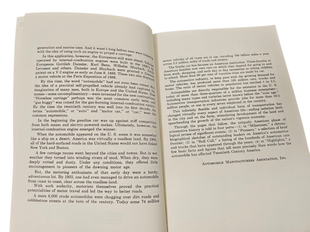 Vintage book open pages with dense text blocks and visible section headings