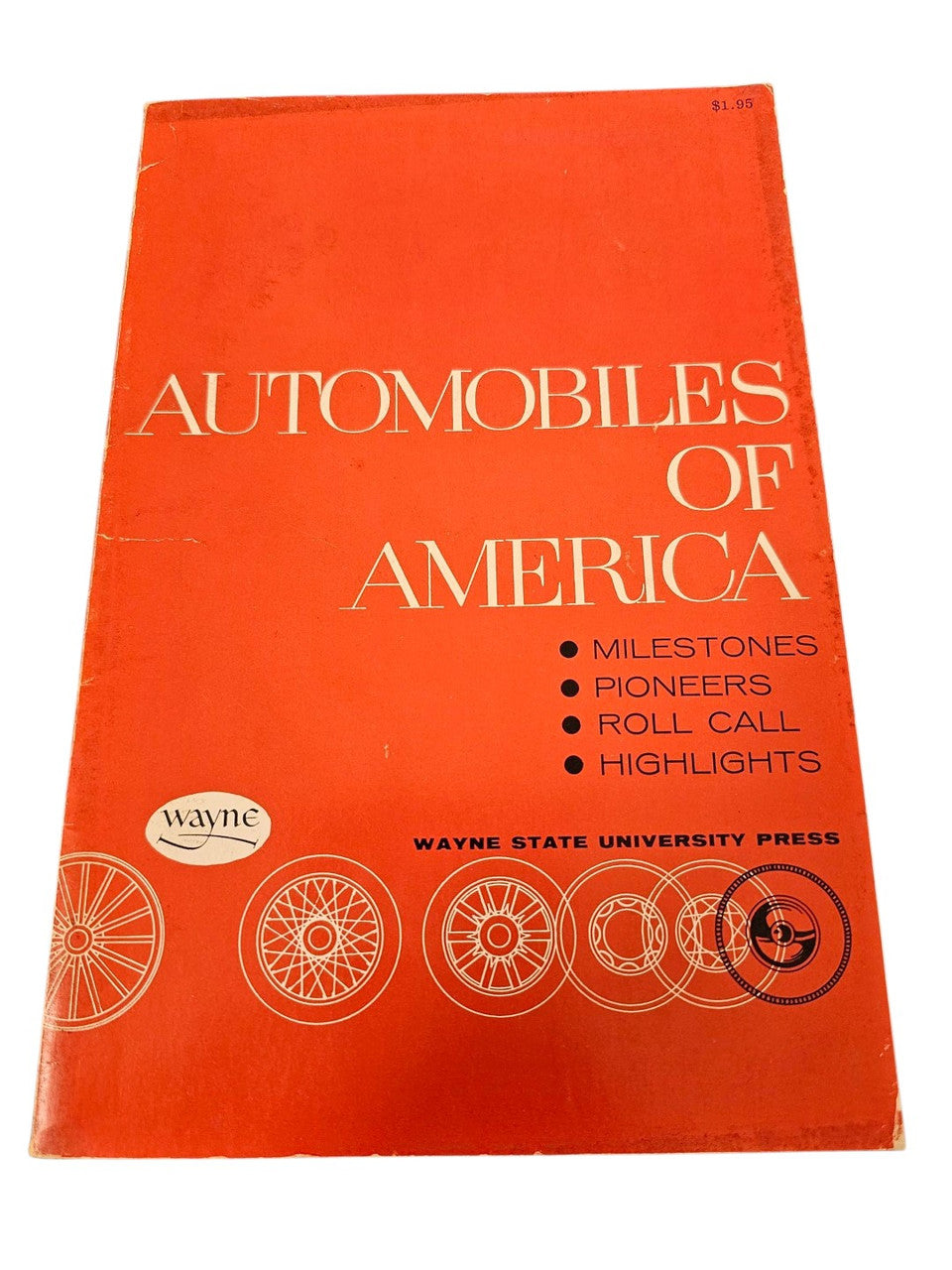Orange vintage book cover with gold “AUTOMOBILES OF AMERICA” lettering and icons