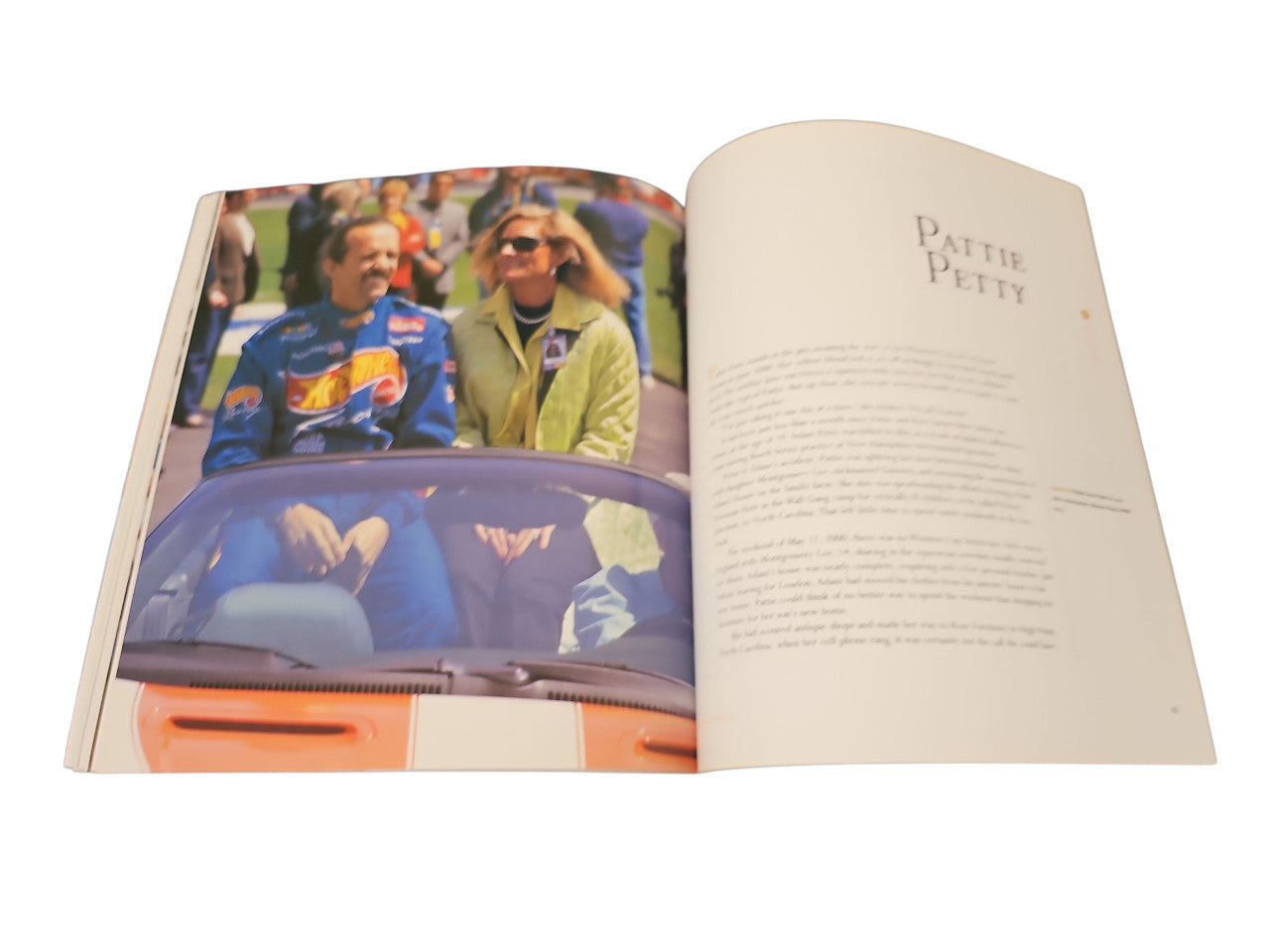 Open book with a car-related photo on the left and printed text on the right