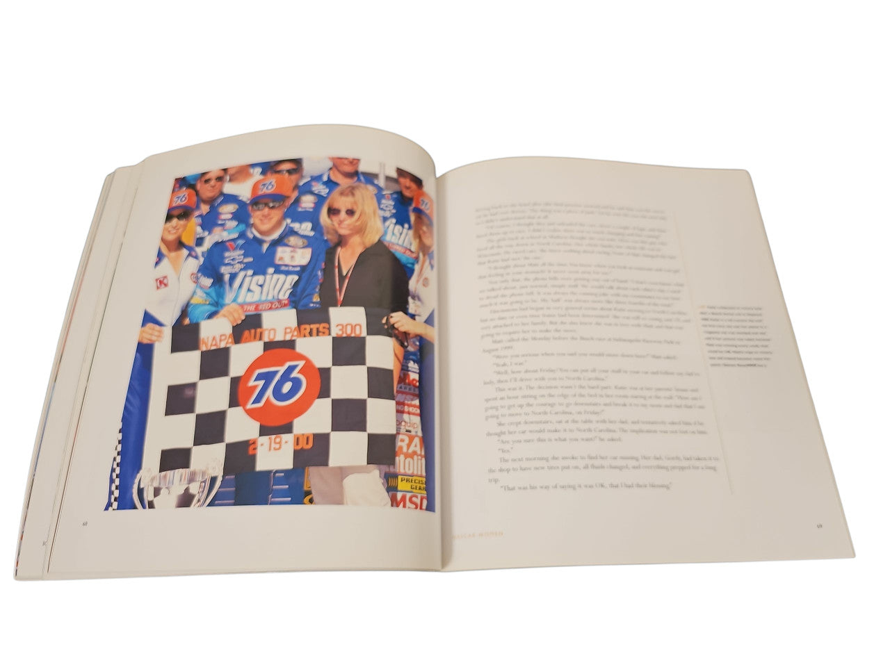Open book with a racetrack photo on the left and printed text on the right
