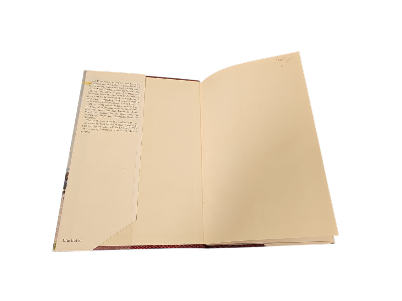 Open vintage book with cream pages and a small text block on the left page.