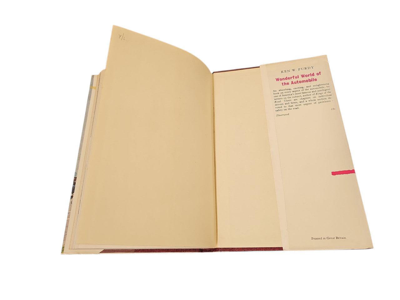 Open vintage book with printed cover page on the right and blank cream page on left.