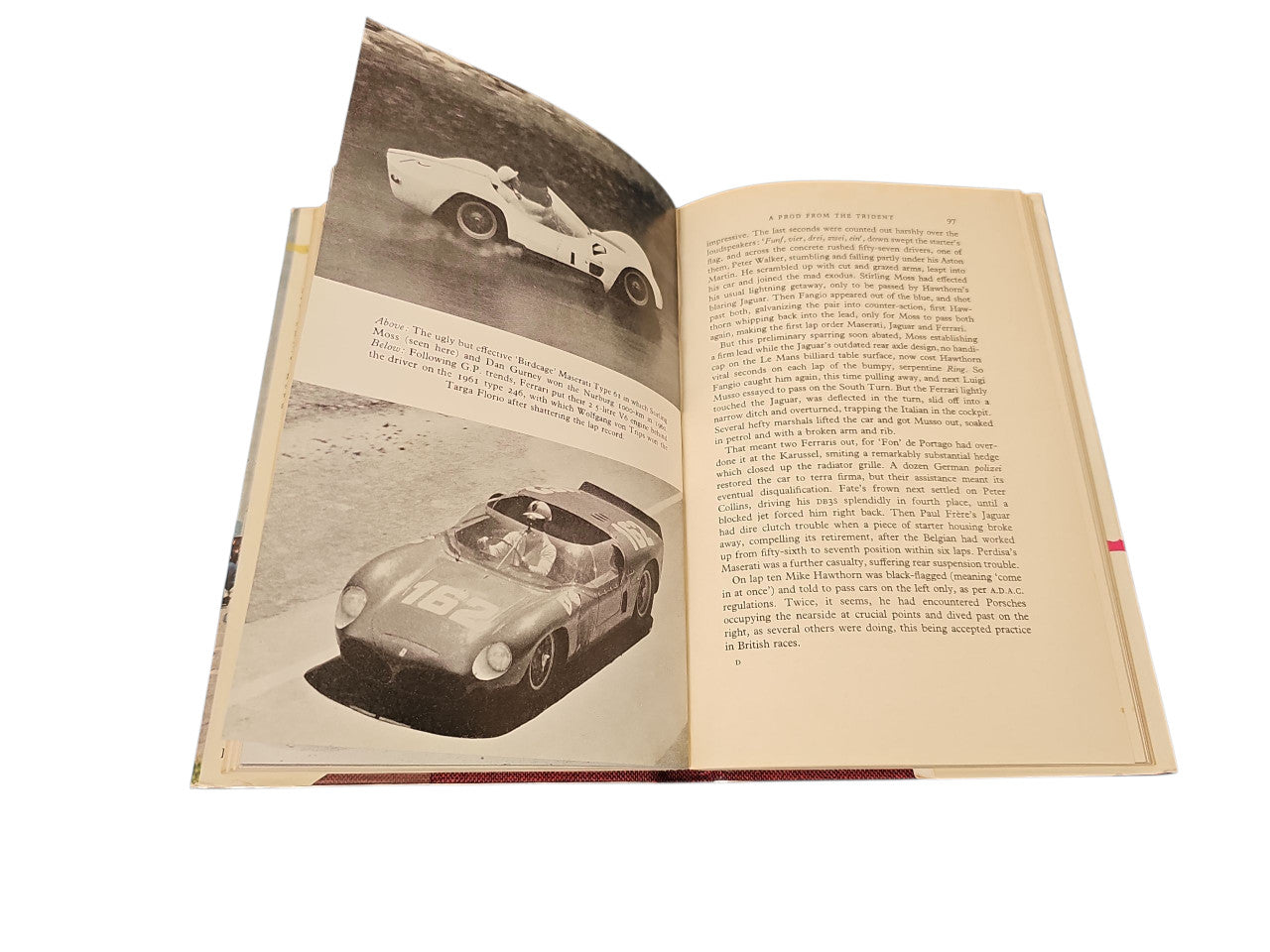 Open vintage book with black-and-white car photos on the left and text on the right.