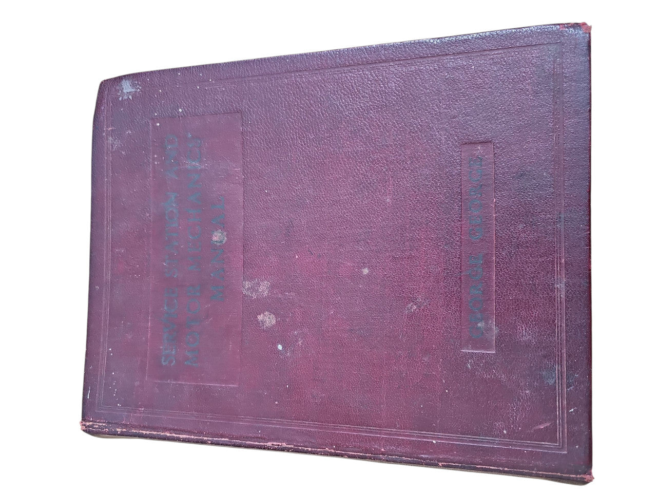 Burgundy hardcover manual book with embossed title panel on front cover