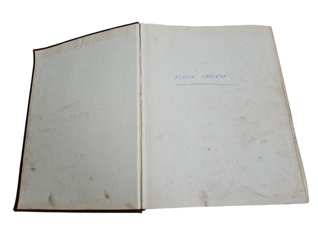 Open vintage manual book with two blank pages and visible spine crease